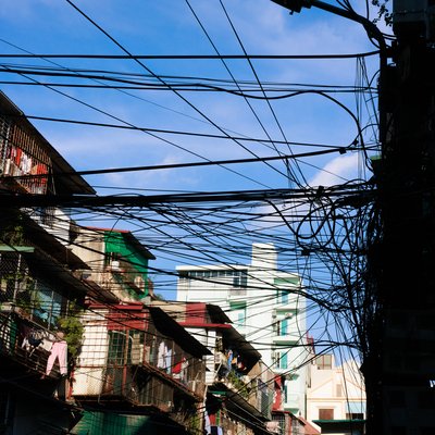 Bức ảnh chụp các dây điện chằng chịt phía trên các toà nhà chung cư trong một khu đô thị. Cảnh vật tạo cảm giác bình yên và phản ánh đời sống thường nhật ở thành phố.